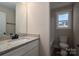 Bathroom with granite countertop, white cabinets, and a tub at 511 E Sycamore St, Lincolnton, NC 28092