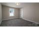 Charming bedroom with grey carpet and an open door to the hallway at 511 E Sycamore St, Lincolnton, NC 28092