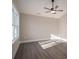 Bright bedroom with large window, hardwood floors, and ceiling fan at 511 E Sycamore St, Lincolnton, NC 28092