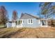 Gray house with white trim, front porch, and shed at 678 Wagner St, Troutman, NC 28166