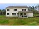Exterior home view showcasing the backyard and covered patio seating area at 1875 Rock Hill Church Rd # 4, Matthews, NC 28104
