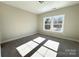 Bedroom featuring carpet floors, a ceiling light, and a double-hung window at 1875 Rock Hill Church Rd # 4, Matthews, NC 28104