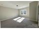 Bright bedroom featuring carpet floors, a ceiling light, and a double-hung window at 1875 Rock Hill Church Rd # 4, Matthews, NC 28104