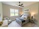Cozy bedroom with a large window, a ceiling fan, and neutral decor at 1875 Rock Hill Church Rd # 4, Matthews, NC 28104