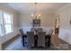 Elegant dining room featuring wainscoting, a modern chandelier, and ample natural light at 1875 Rock Hill Church Rd # 4, Matthews, NC 28104