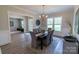 Stylish dining room featuring wainscoting, a modern chandelier, and views to other living areas at 1875 Rock Hill Church Rd # 4, Matthews, NC 28104