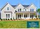 Charming two-story home with gray siding, black roof, and manicured front lawn showcasing closing cost promotion at 1875 Rock Hill Church Rd # 4, Matthews, NC 28104
