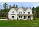 Beautiful two-story home featuring a well-manicured lawn, white siding, and black trim at 1875 Rock Hill Church Rd # 4, Matthews, NC 28104