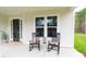 Inviting front porch with rocking chairs, a lantern, and a welcoming entry at 1875 Rock Hill Church Rd # 4, Matthews, NC 28104