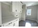 Laundry room with tiled floor, cabinets, a countertop, washer and dryer hookups, and natural light at 1875 Rock Hill Church Rd # 4, Matthews, NC 28104