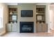 Living room with a fireplace, built-in bookshelves, and neutral paint at 1875 Rock Hill Church Rd # 4, Matthews, NC 28104