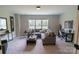 Bright living room with a comfortable sofa, ottoman, and natural light streaming through the window at 1875 Rock Hill Church Rd # 4, Matthews, NC 28104
