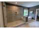 Elegant bathroom showcasing a glass-enclosed shower, soaking tub, and neutral tile work at 1875 Rock Hill Church Rd # 4, Matthews, NC 28104