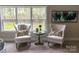 This sunlit sitting area includes two chairs and a round table, perfect for enjoying views of the surrounding nature at 1875 Rock Hill Church Rd # 4, Matthews, NC 28104