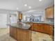 Island kitchen with granite countertops and wood cabinets at 2123 Hartwell Ln, Fort Mill, SC 29707