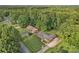Aerial view of a brick home with landscaping surrounded by mature trees in a desirable neighborhood at 216 Delview Dr, Cherryville, NC 28021