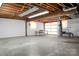 Unfinished basement featuring an open layout, exposed beams, and an attached garage, providing ample space at 216 Delview Dr, Cherryville, NC 28021