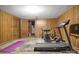 Basement area with wood paneling and workout equipment; perfect for a home gym or recreational area at 216 Delview Dr, Cherryville, NC 28021