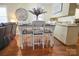 Inviting dining area with white chairs and a dark wooden table, complemented by hardwood floors at 216 Delview Dr, Cherryville, NC 28021