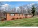Charming red brick home with a well-maintained lawn and mature trees creating a serene curb appeal at 216 Delview Dr, Cherryville, NC 28021