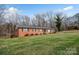 Inviting red brick home set on a spacious lawn with mature trees adding to the property's charm at 216 Delview Dr, Cherryville, NC 28021