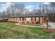 Attractive red brick home with manicured lawn and walkway enhancing the curb appeal and inviting entrance at 216 Delview Dr, Cherryville, NC 28021