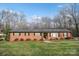 Quaint red brick home featuring a neatly kept lawn and classic design elements for a welcoming atmosphere at 216 Delview Dr, Cherryville, NC 28021