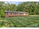 A ranch style brick home accented by shutters with a well maintained lawn at 216 Delview Dr, Cherryville, NC 28021