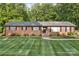 Charming single-story brick home with black shutters and a beautifully manicured lawn at 216 Delview Dr, Cherryville, NC 28021