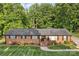 Classic brick home featuring a welcoming entrance, well-kept landscaping, and a shingled roof at 216 Delview Dr, Cherryville, NC 28021