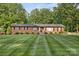 Traditional brick home with a neatly striped lawn and classic architectural details at 216 Delview Dr, Cherryville, NC 28021