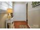 Cozy hallway with white paneling, hardwood floors, and a decorative table adding character to the space at 216 Delview Dr, Cherryville, NC 28021