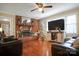 Cozy living room features a fireplace, hardwood floors, and a ceiling fan at 216 Delview Dr, Cherryville, NC 28021