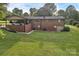 Brick home with a carport and well-maintained backyard offering privacy and outdoor living space at 216 Delview Dr, Cherryville, NC 28021