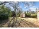 Lush backyard with shade trees and a storage shed at 2630 Druid Hills Way, Charlotte, NC 28206