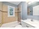 Bathroom featuring tiled walls, a tub with shower, and a window at 2630 Druid Hills Way, Charlotte, NC 28206