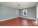 Bright bedroom features hardwood floors, a single window, and neutral paint at 2630 Druid Hills Way, Charlotte, NC 28206