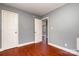 Bedroom with two doors, hardwood floors, and neutral walls at 2630 Druid Hills Way, Charlotte, NC 28206