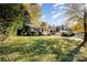 Lush front yard of a charming home with mature trees and well-maintained landscaping at 2630 Druid Hills Way, Charlotte, NC 28206