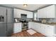 Updated kitchen featuring stainless steel appliances, granite countertops, and white cabinetry at 2630 Druid Hills Way, Charlotte, NC 28206