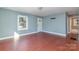 Spacious living room with a large window, hardwood floors, and white trim at 2630 Druid Hills Way, Charlotte, NC 28206