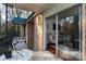 Small balcony with seating and view of trees, accessible from sliding door at 4754 Hedgemore Dr # S, Charlotte, NC 28209