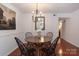 Elegant dining room with hardwood floors and a modern chandelier at 4754 Hedgemore Dr # S, Charlotte, NC 28209