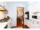 White kitchen with stainless steel appliances and view into dining area at 4754 Hedgemore Dr # S, Charlotte, NC 28209