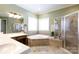 Bathroom with double sinks, a garden tub surrounded by tiles and a glass-enclosed shower at 1038 Rolling Park Ln, Fort Mill, SC 29715