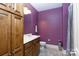 Cozy bathroom with wooden cabinets, purple walls, and tile floors at 1038 Rolling Park Ln, Fort Mill, SC 29715