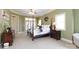 Main bedroom with post bed, carpet floors, and french doors at 1038 Rolling Park Ln, Fort Mill, SC 29715