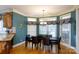 Dining area featuring large windows, hardwood floors, and a modern chandelier over a dark wood table at 1038 Rolling Park Ln, Fort Mill, SC 29715