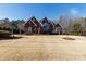 Imposing two-story brick home featuring a manicured lawn and mature landscaping at 1038 Rolling Park Ln, Fort Mill, SC 29715