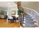 Foyer featuring a staircase with iron spindles, hardwood floors, and decorative wall trim at 1038 Rolling Park Ln, Fort Mill, SC 29715